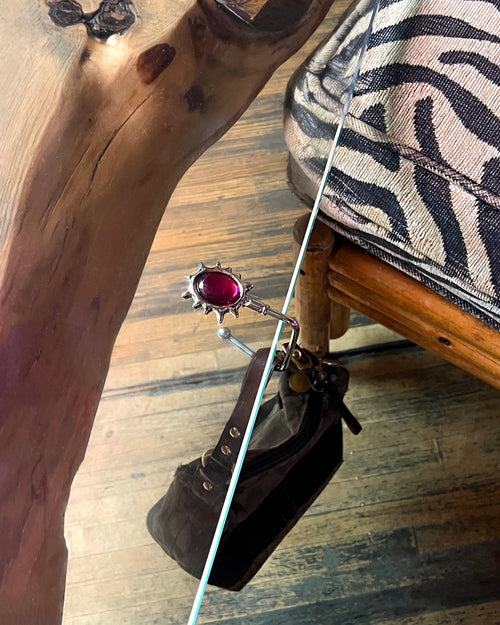 Close-up of a wooden surface with a zebra-patterned cushion and a handbag.